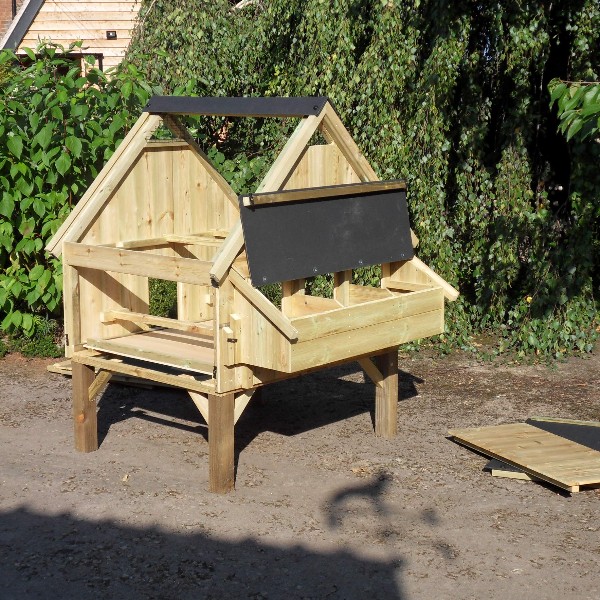 A chicken house with its roof and sides removed for deep cleaning
