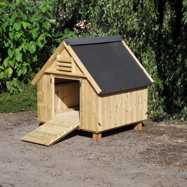 A wooden duck house with the door open
