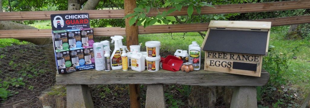 a selection of chicken keeping accessories displayed on a wooden bench